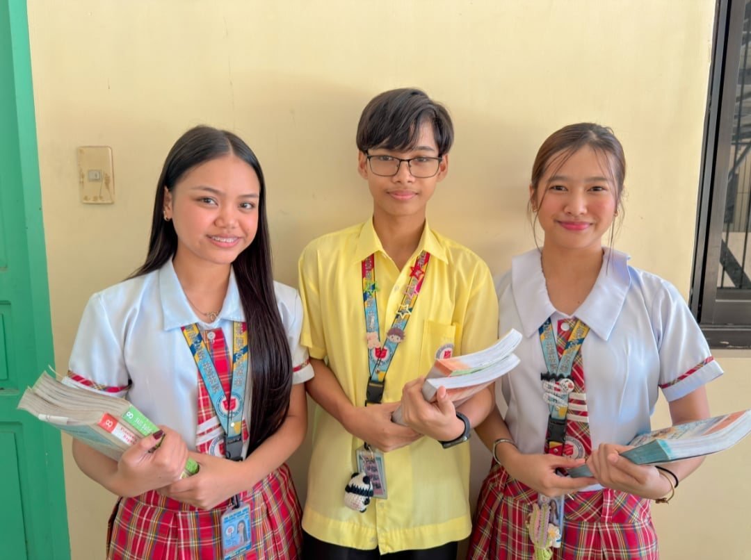 Smiling TSAESI students holding their books